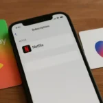 Google Play and Apple gift cards next to a phone showing Netflix billed through app store subscriptions.